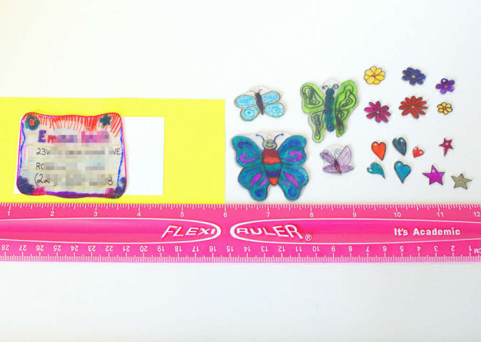 Final plastic ID card and zipper pulls after shrinking